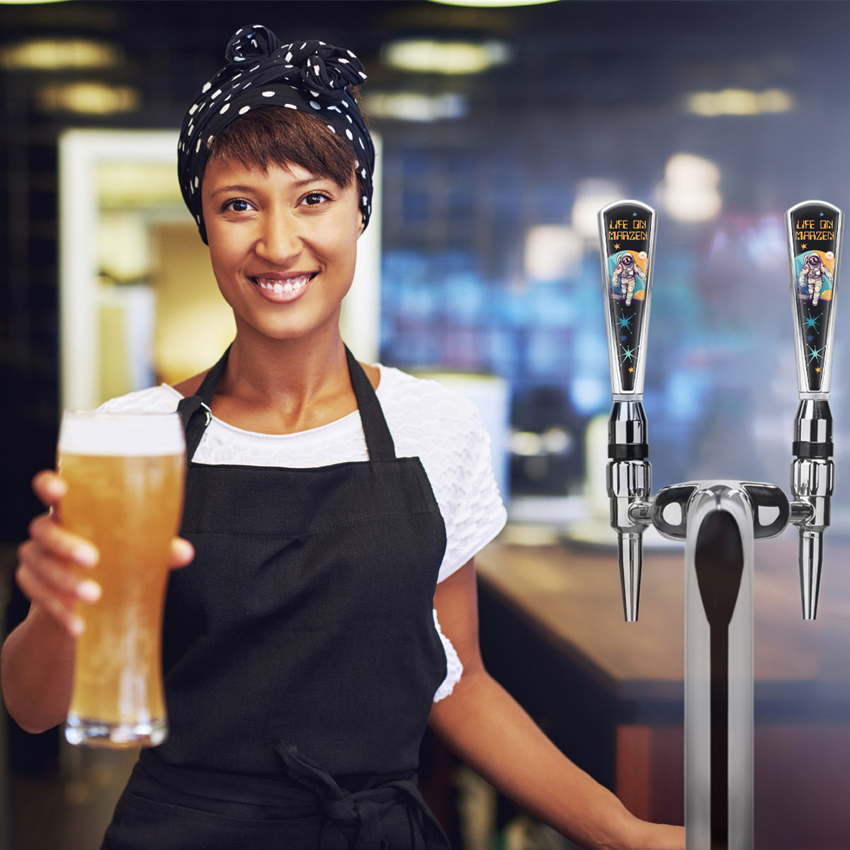 barmaid serving a beer with branded handle in background